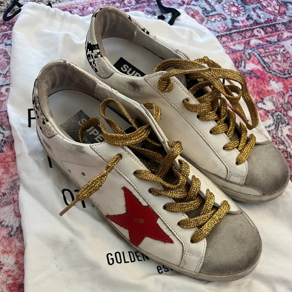 Red black and white golden goose with dust bag